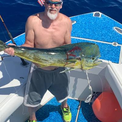 a man holding a fish on a boat