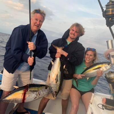 a person holding a fish on a boat