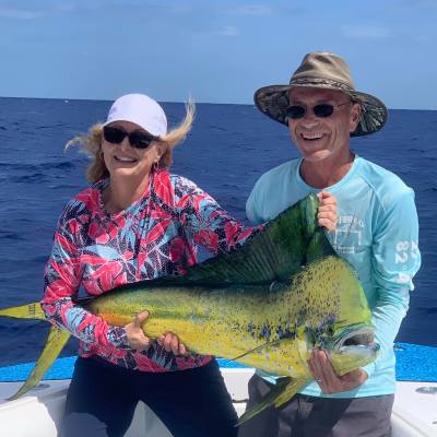 a person holding a fish in the water