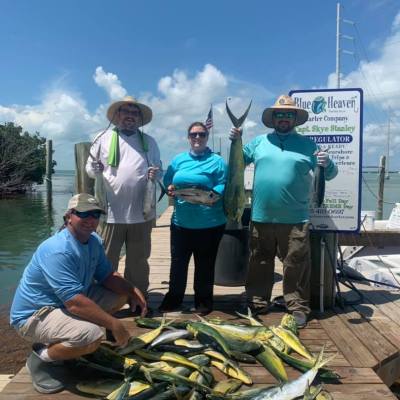 a group of people standing in front of a fish